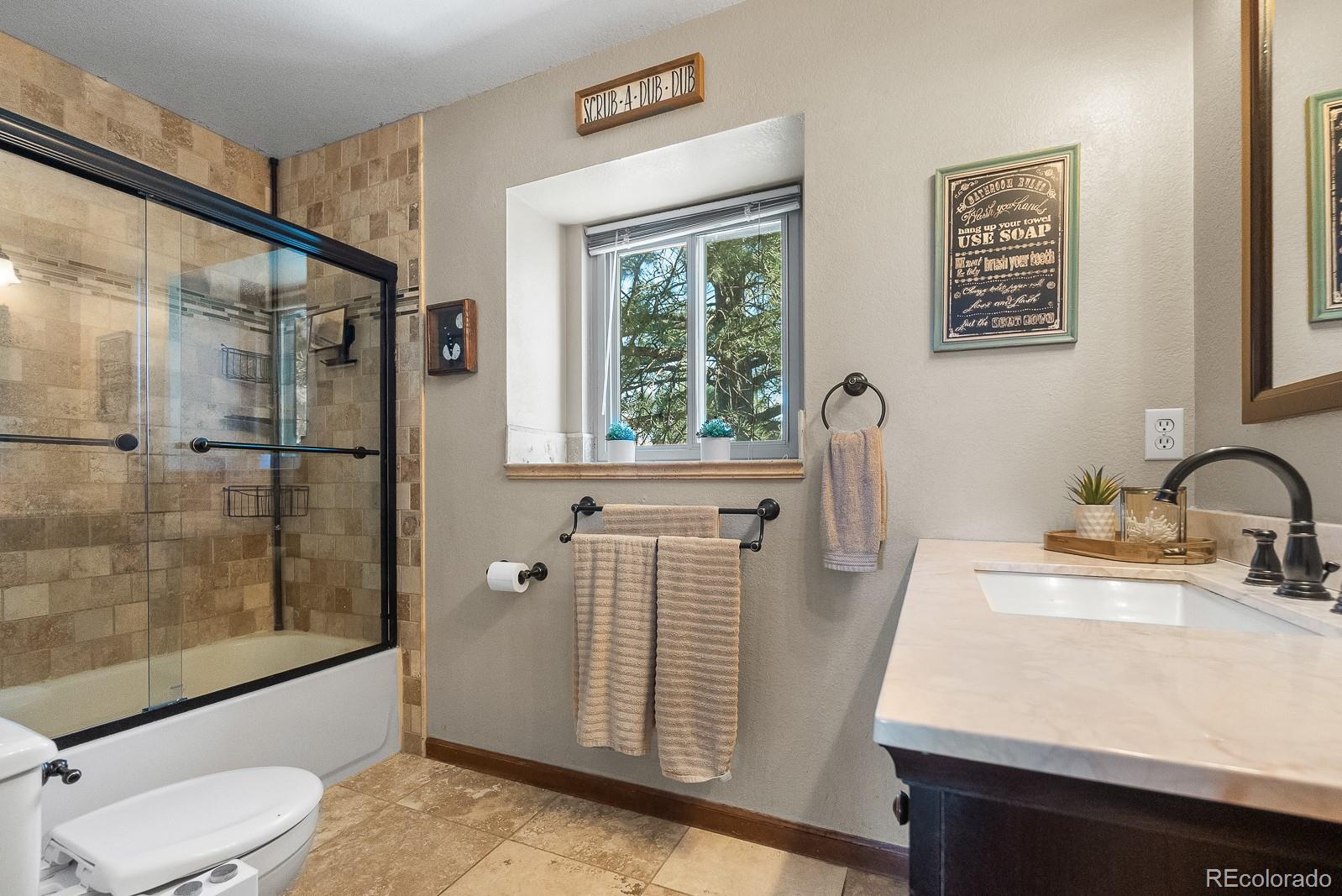 3163 Windstream Lane Elizabeth, CO 80107 - Photo 16 of 48 a bathroom with a sink a toilet and shower