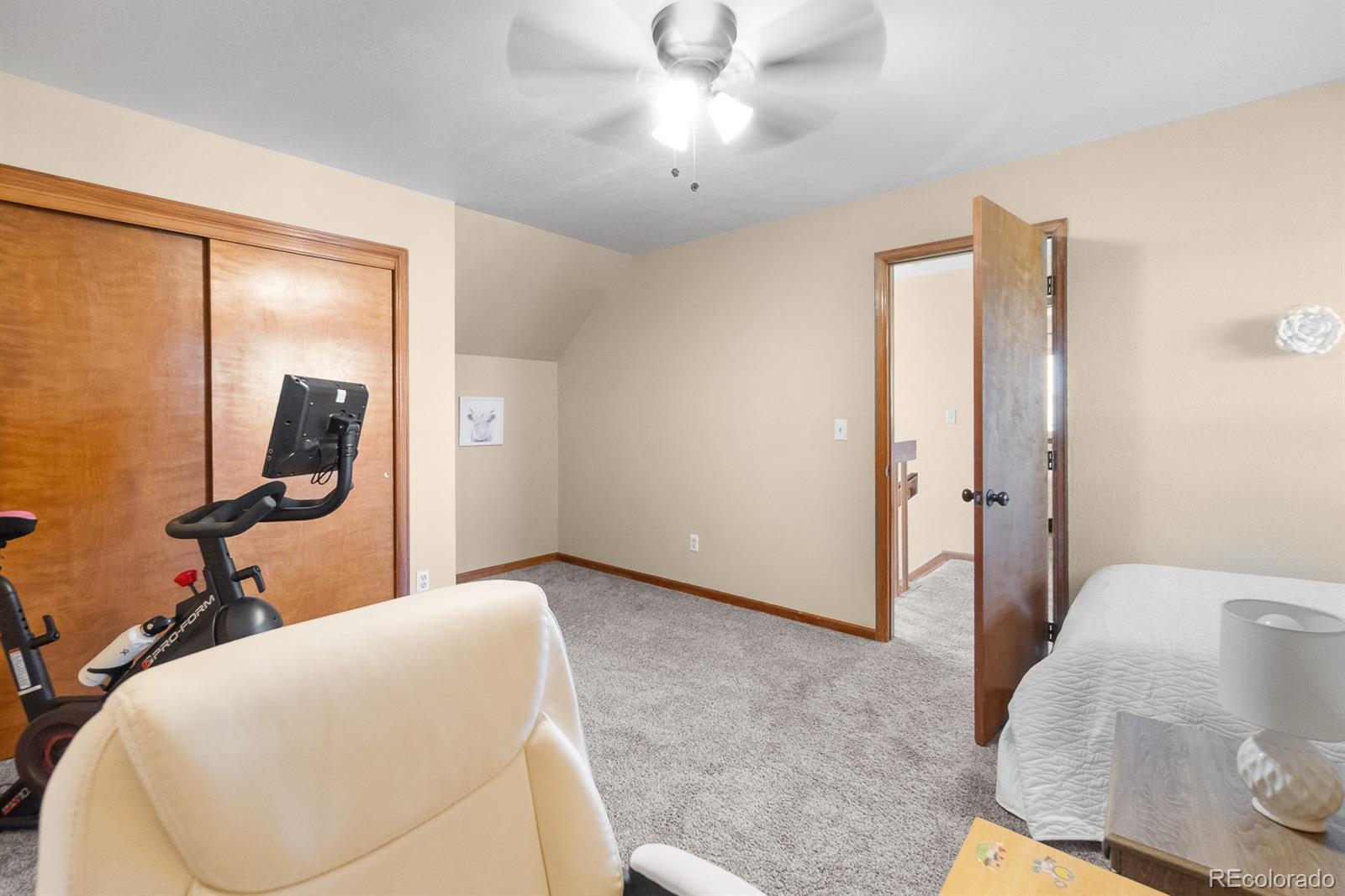 3163 Windstream Lane Elizabeth, CO 80107 - Photo 22 of 48 a bedroom with a bed and a mirror