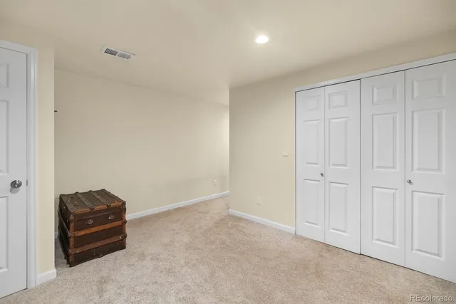 a living room with furniture a couch and kitchen view