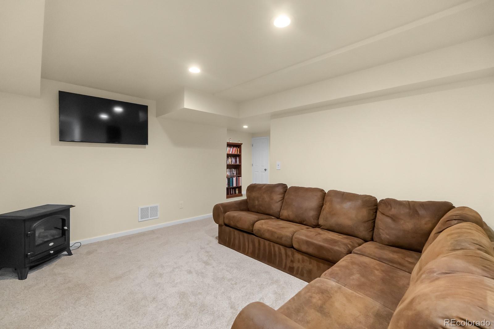3163 Windstream Lane Elizabeth, CO 80107 - Photo 26 of 48 a living room with furniture and a flat screen tv