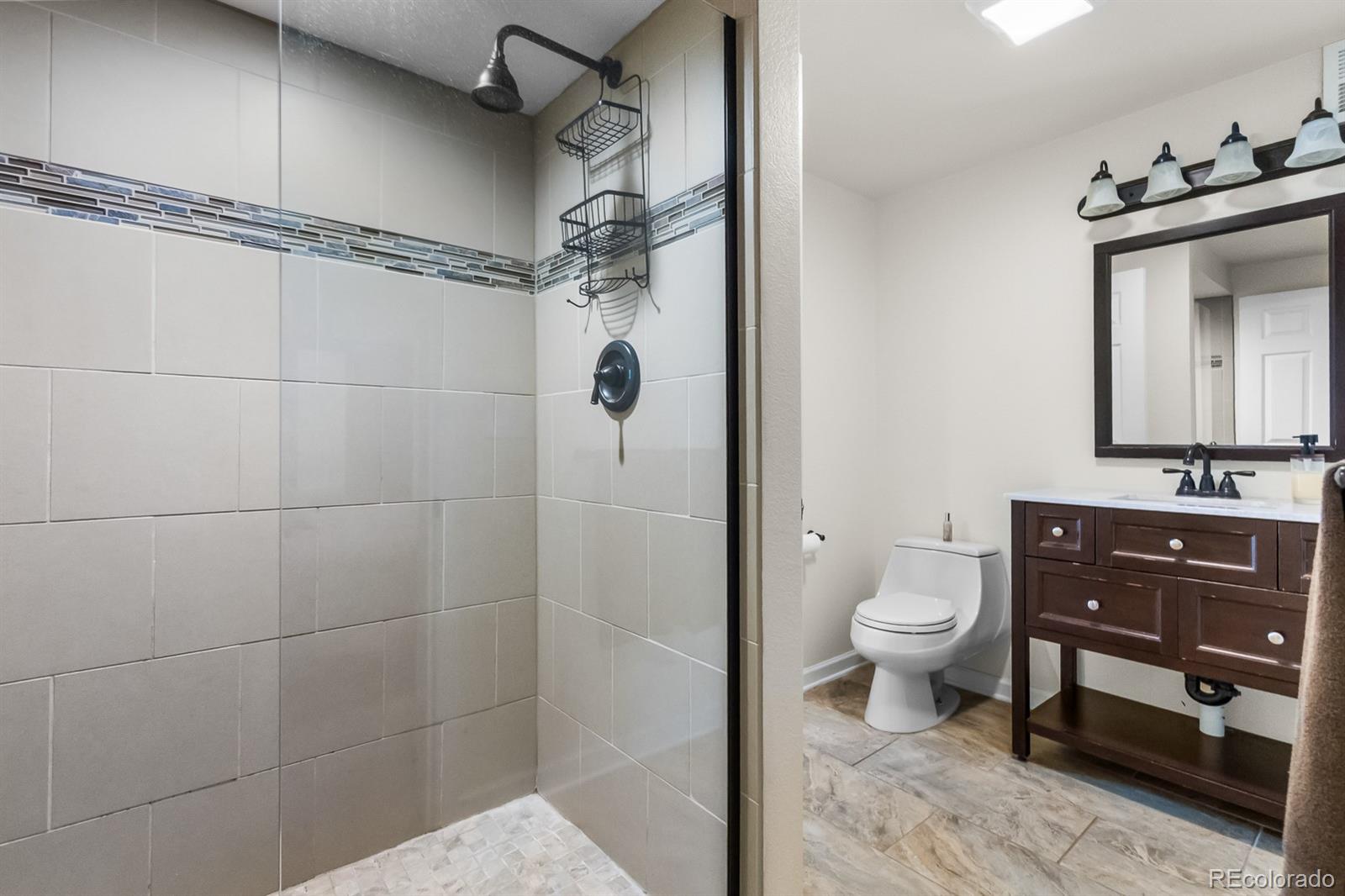 3163 Windstream Lane Elizabeth, CO 80107 - Photo 29 of 48 a bathroom with a sink toilet and shower