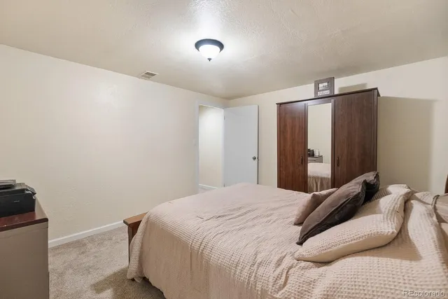 a bed room with a bed and with chair