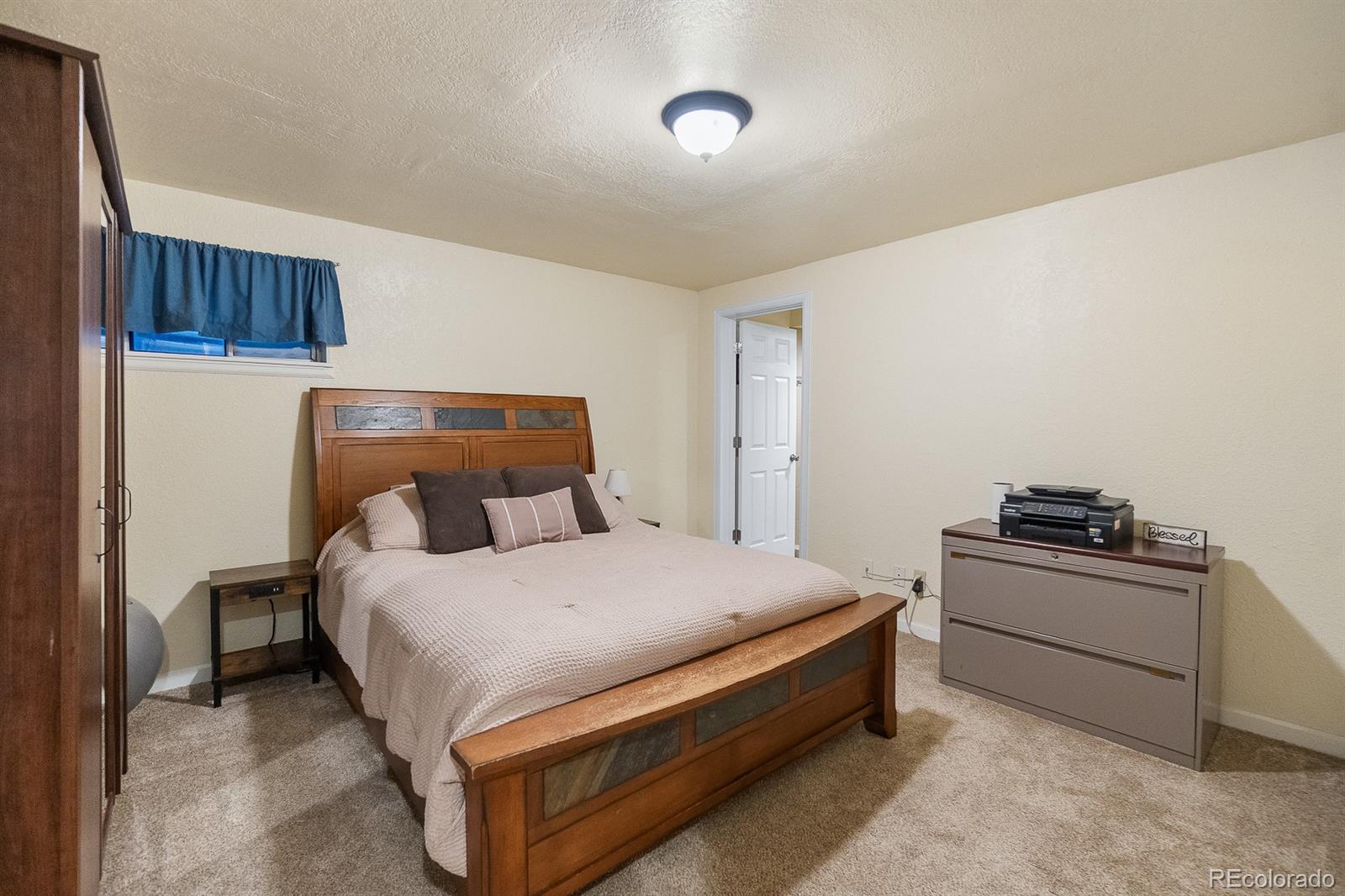 3163 Windstream Lane Elizabeth, CO 80107 - Photo 31 of 48 a bed room with a bed and with chair