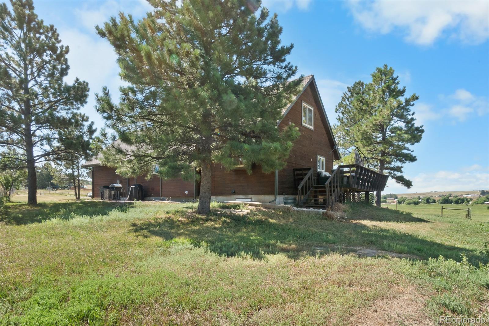 3163 Windstream Lane Elizabeth, CO 80107 - Photo 39 of 48 a backyard of a house with lots of green space and fountain