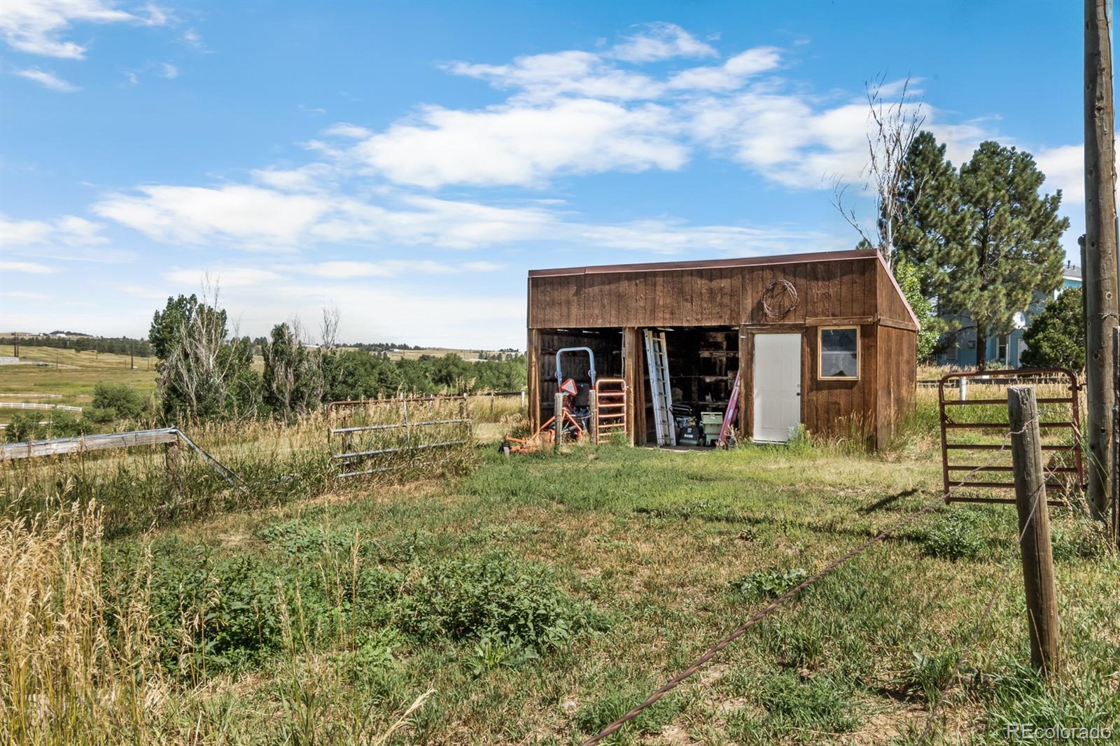 3163 Windstream Lane Elizabeth, CO 80107 - Photo 41 of 48 a view of a house with a yard and potted plants