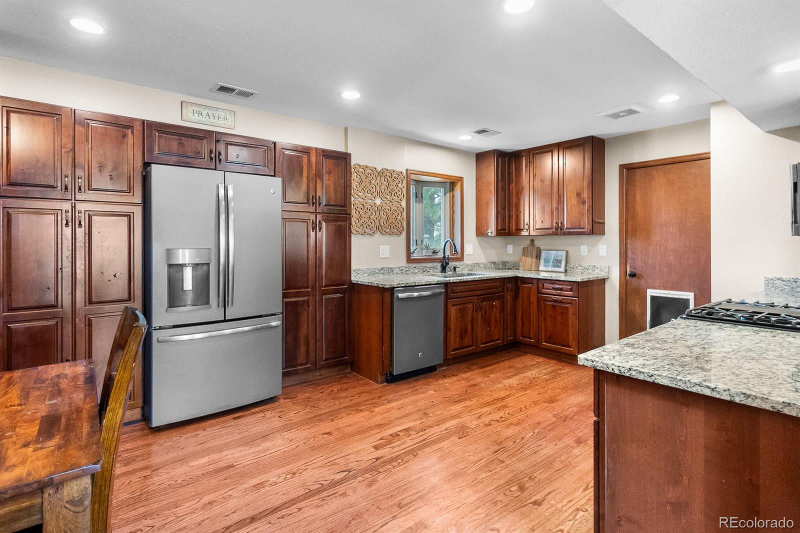 3163 Windstream Lane Elizabeth, CO 80107 - Photo 6 of 48 a kitchen with stainless steel appliances granite countertop a refrigerator a sink a stove a washer dryer and a refrigerator