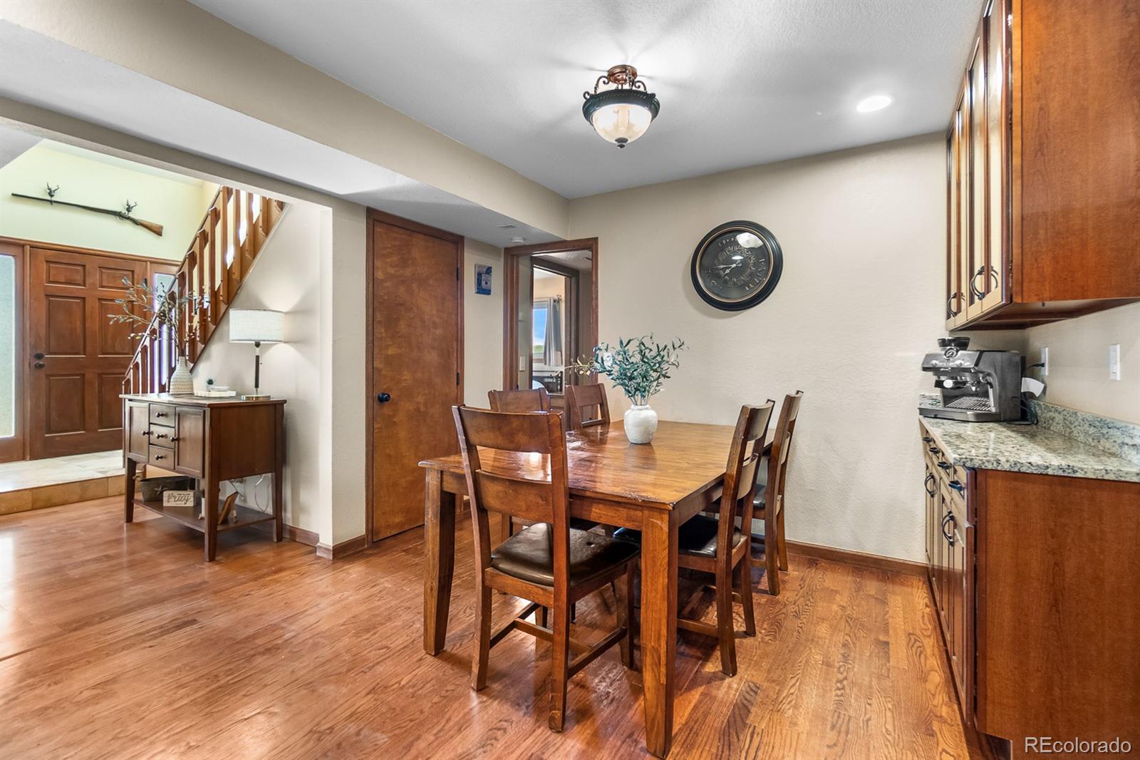 3163 Windstream Lane Elizabeth, CO 80107 - Photo 10 of 48 a view of a dining room with furniture window and wooden floor