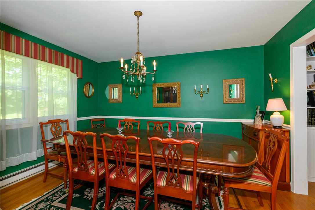 2516 Rachael Lane Orefield, PA 18069 - Photo 10 of 45 A classic dining room features an elegant chandelier and rich hardwood flooring, perfect for formal gatherings.