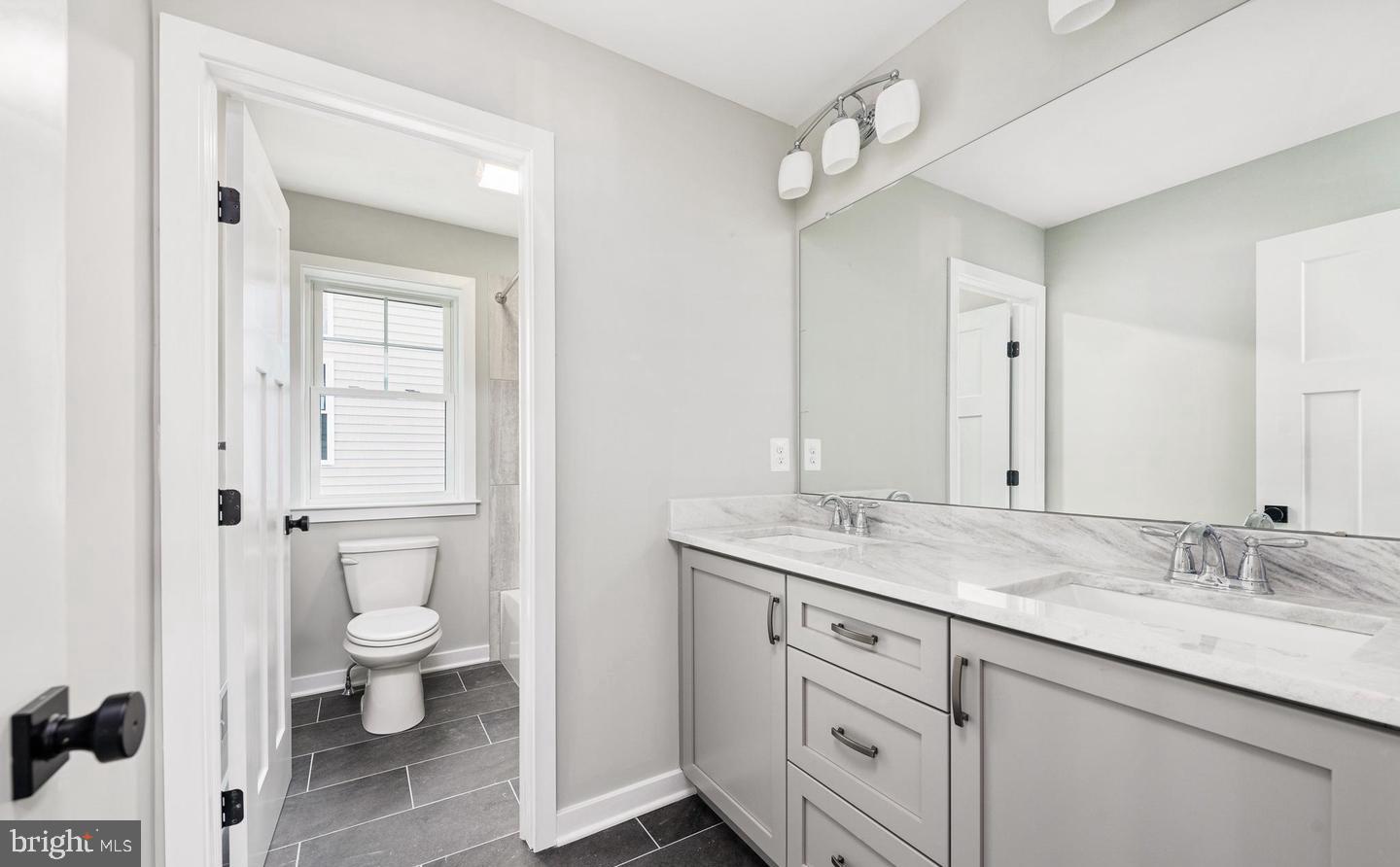 2 Cynwyd Broomall, PA 19008 - Photo 10 of 10 a bathroom with a granite countertop sink a toilet and a mirror