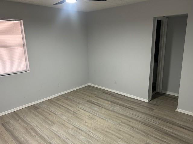 1833 Terry Mill Road Southeast Atlanta, GA 30316 - Photo 8 of 22 an empty room with wooden floor and windows