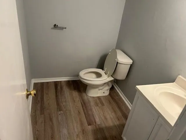 a white toilet sitting next to a white sink