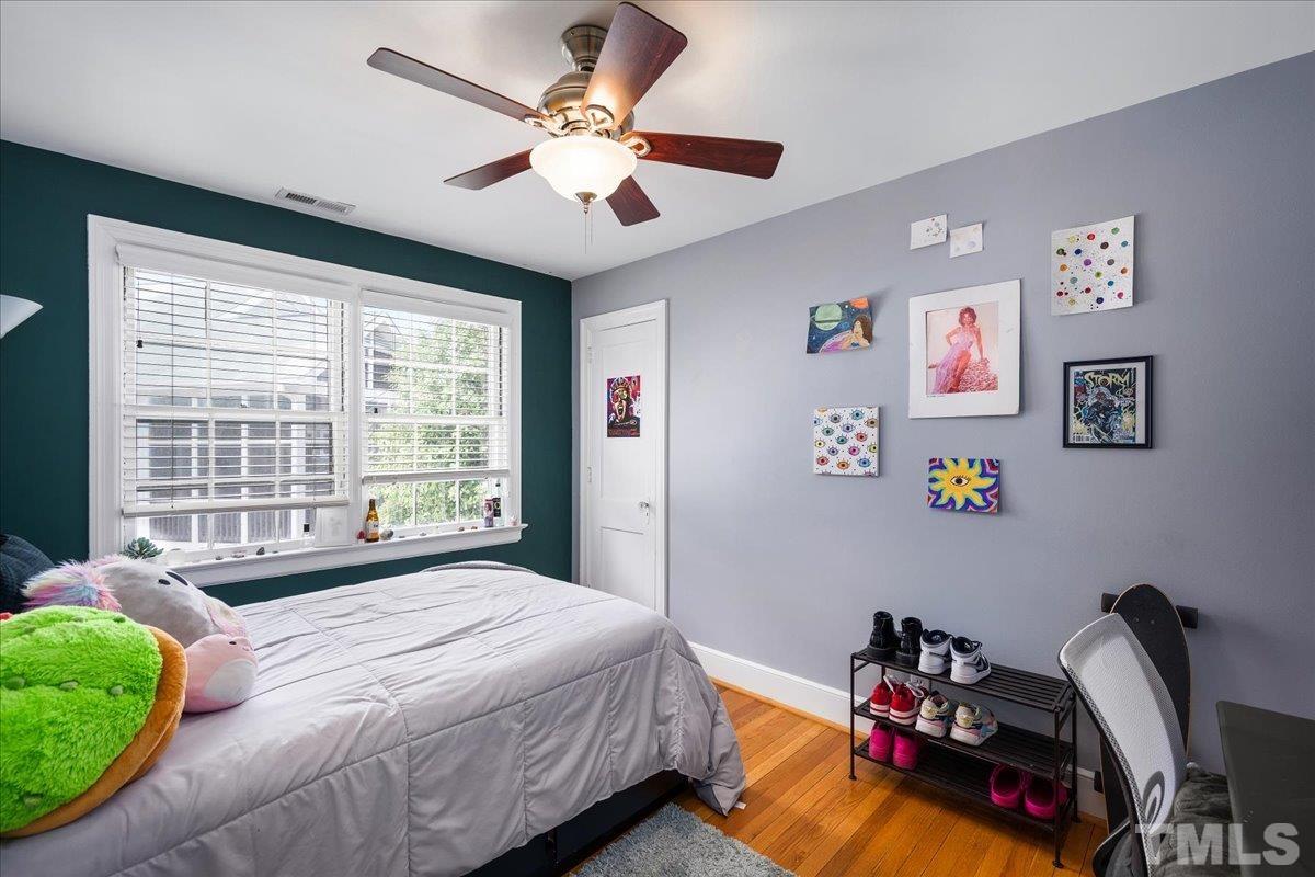 3225 Merriman Avenue Raleigh, NC 27607 - Photo 14 of 19 a bedroom with a bed and a large window