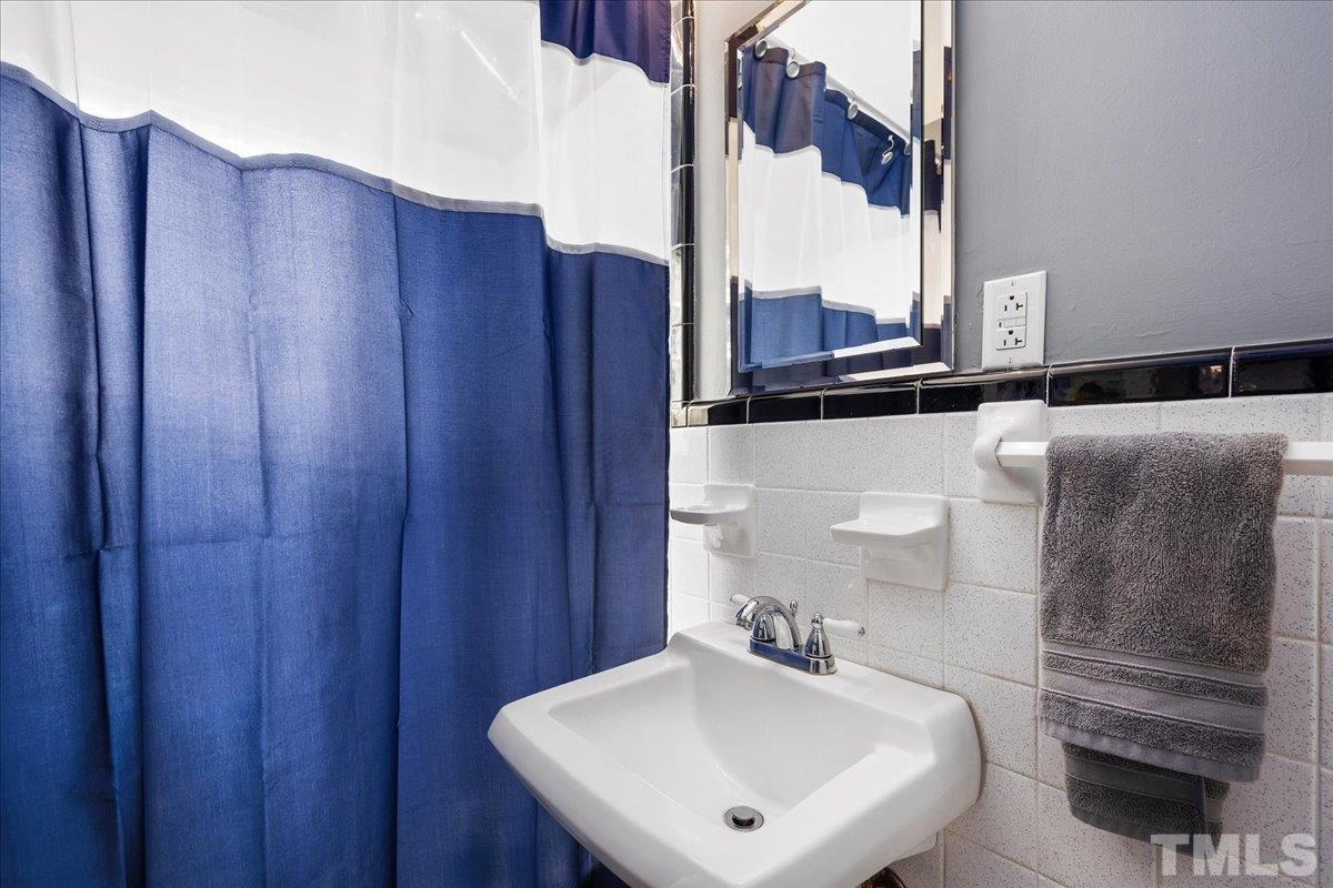3225 Merriman Avenue Raleigh, NC 27607 - Photo 15 of 19 a bathroom with a sink and a mirror