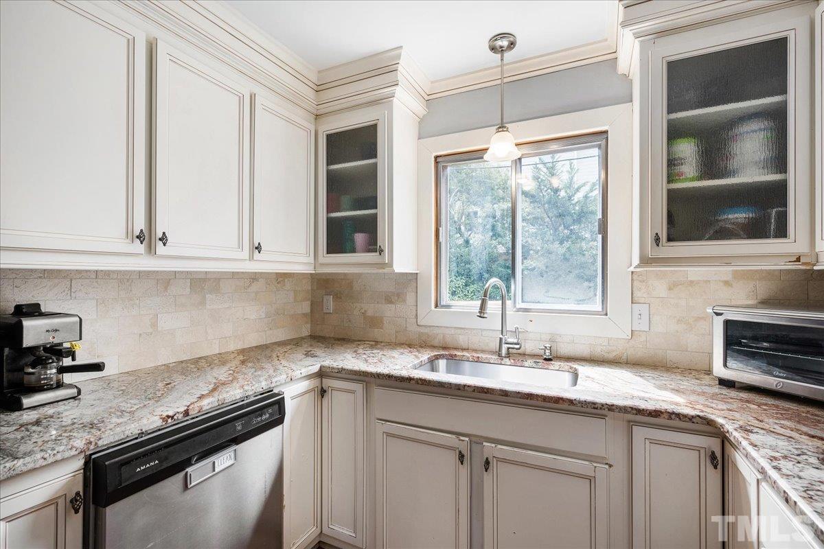 3225 Merriman Avenue Raleigh, NC 27607 - Photo 8 of 19 a kitchen with granite countertop a sink and a window