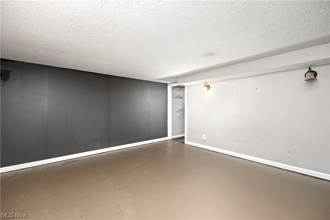 41511 Russia Road Elyria, OH 44035 - Photo 28 of 33 Unfurnished room with concrete flooring and a textured ceiling