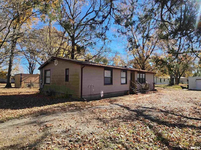 a front view of a house with a yard covered in snow
