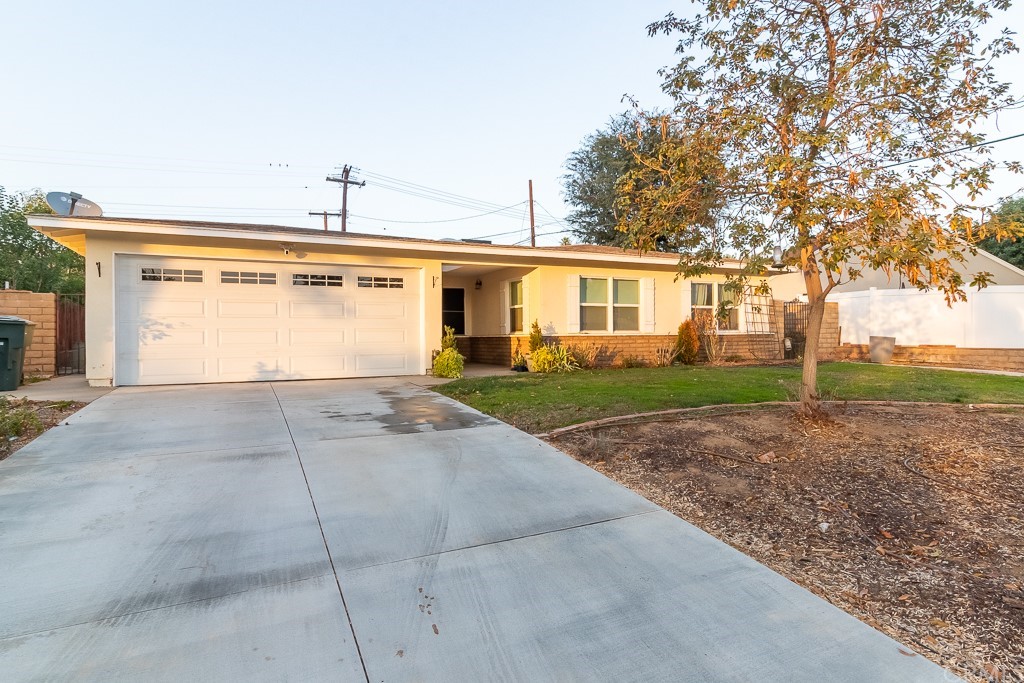2975 Laramie Road Riverside, CA 92506 - Photo 1 of 1 a front view of a house with a yard and garage