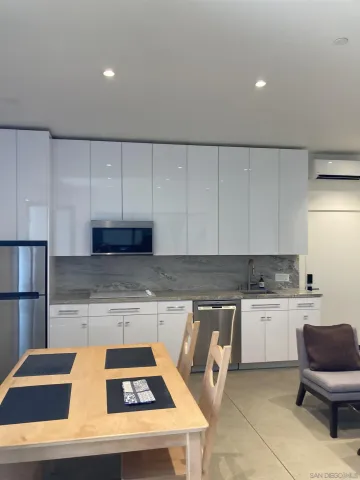 a kitchen with a cabinets and chairs