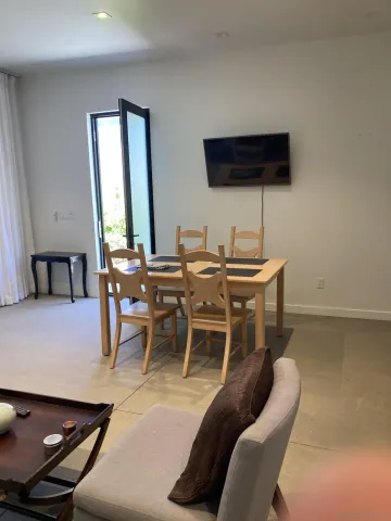 a dining room with furniture and wooden floor