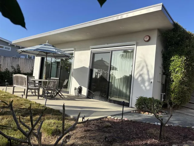 a building outdoor space with patio outdoor seating and plants