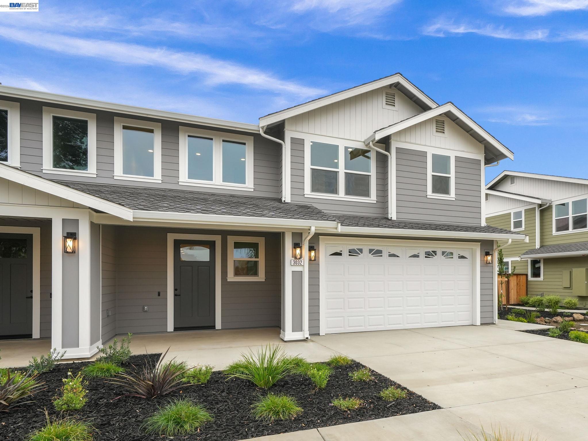 a front view of a house with a yard and garage