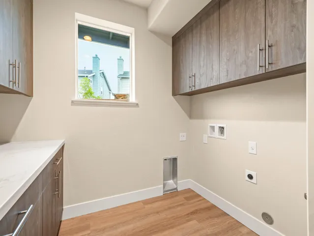 a view of a utility room with cabinets