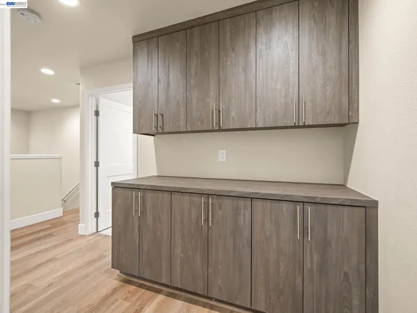 a view of a utility room with wooden floor