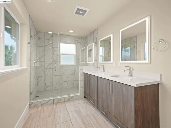 a bathroom with a shower sink and mirror
