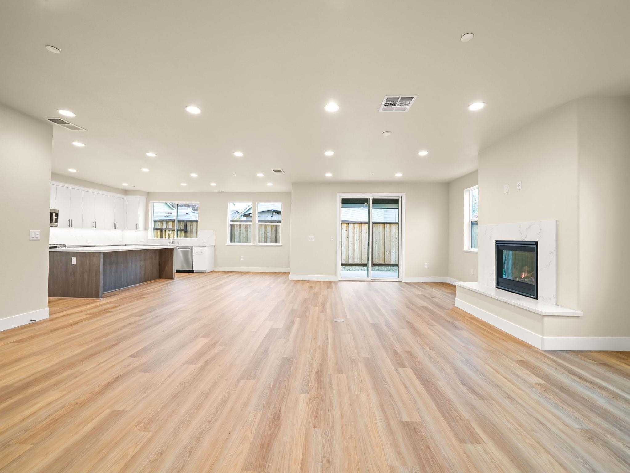 3030 Byron Road Tracy, CA 95377 - Photo 6 of 21 a view of an empty room with wooden floor and a kitchen