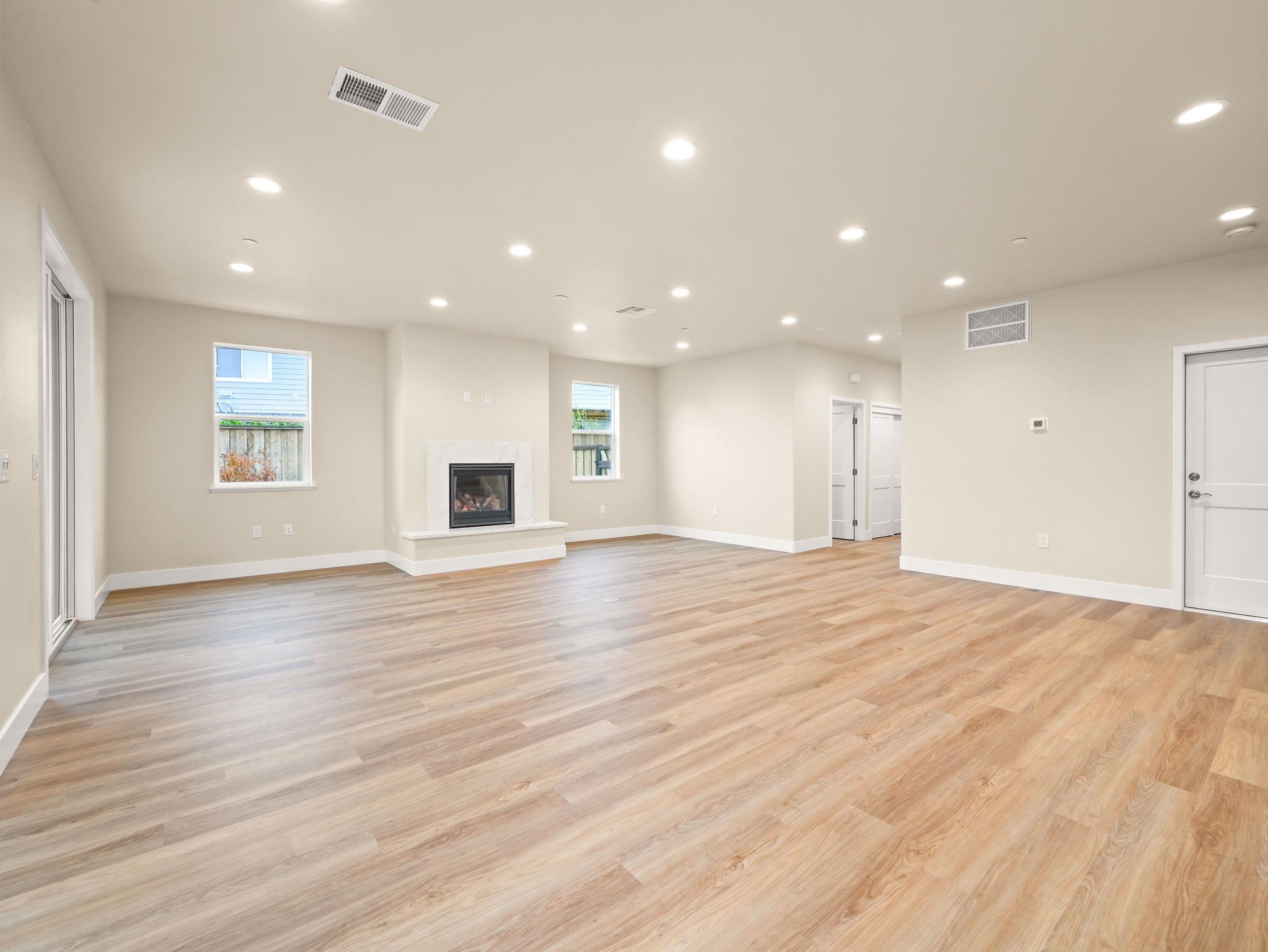 3030 Byron Road Tracy, CA 95377 - Photo 7 of 21 an empty room with wooden floor and windows