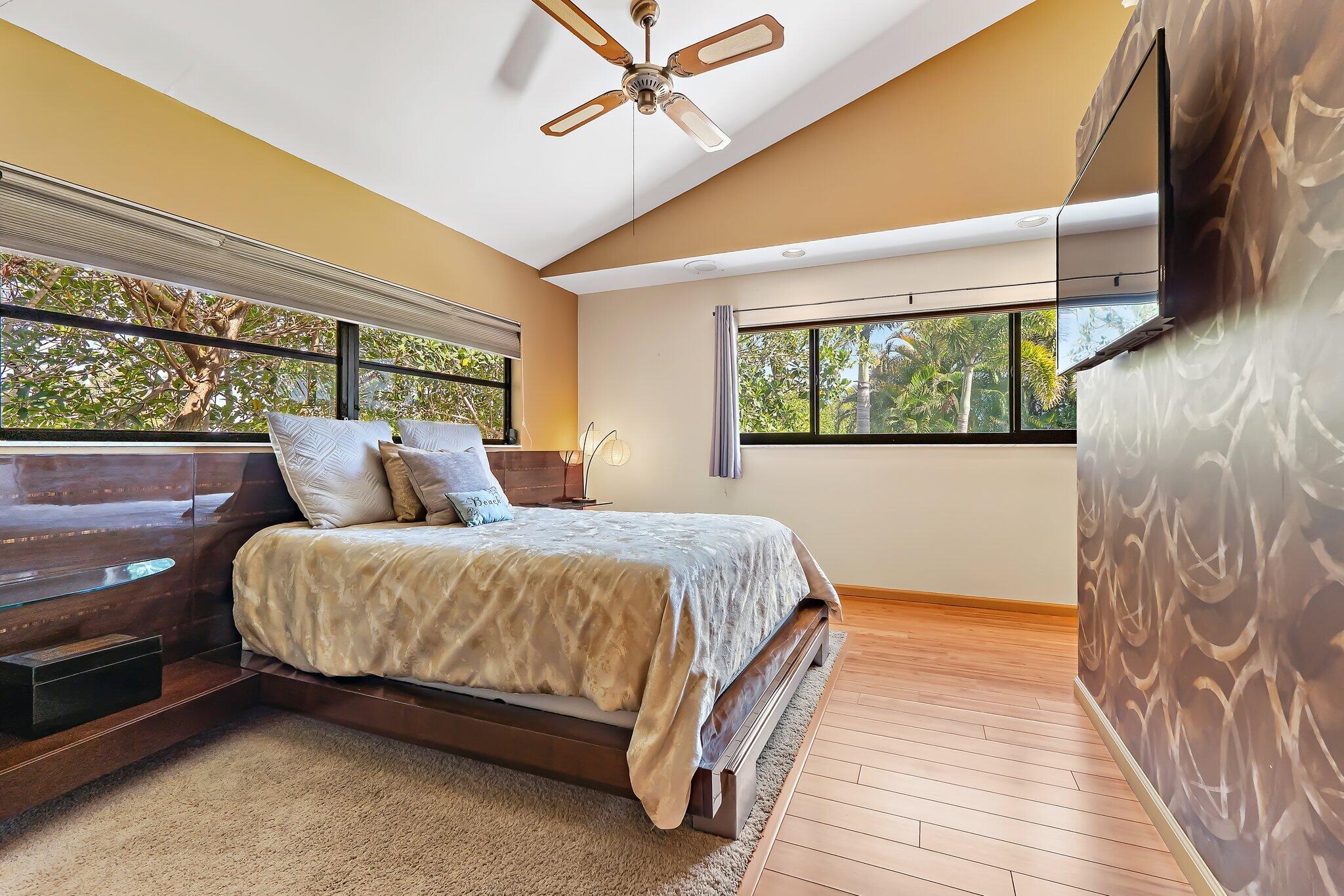 702 Warren Drive Jupiter, FL 33458 - Photo 52 of 76 a spacious bedroom with a bed and window