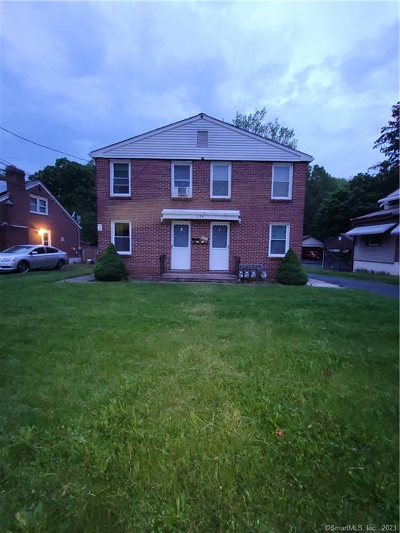 a front view of a house with a garden