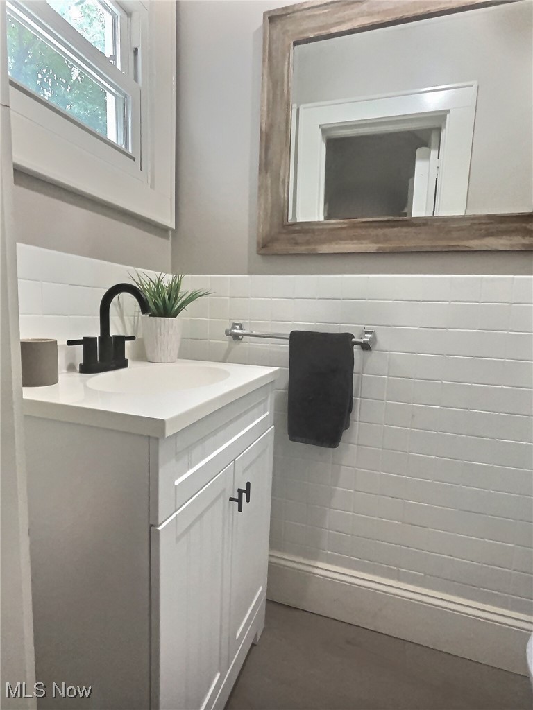 3688 Easton Road Norton, OH 44203 - Photo 23 of 37 Bathroom with tile walls, vanity, and decorative backsplash