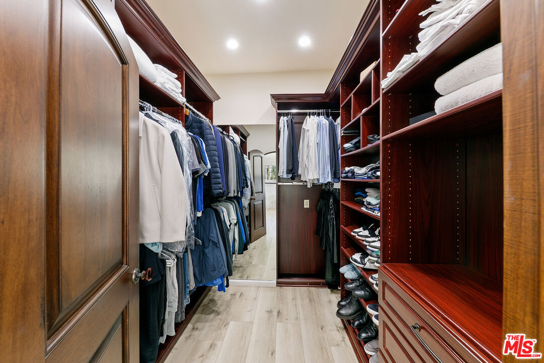 25216 Malibu Road Malibu, CA 90265 - Photo 13 of 21 a view of walk in closet with clothes and shoes