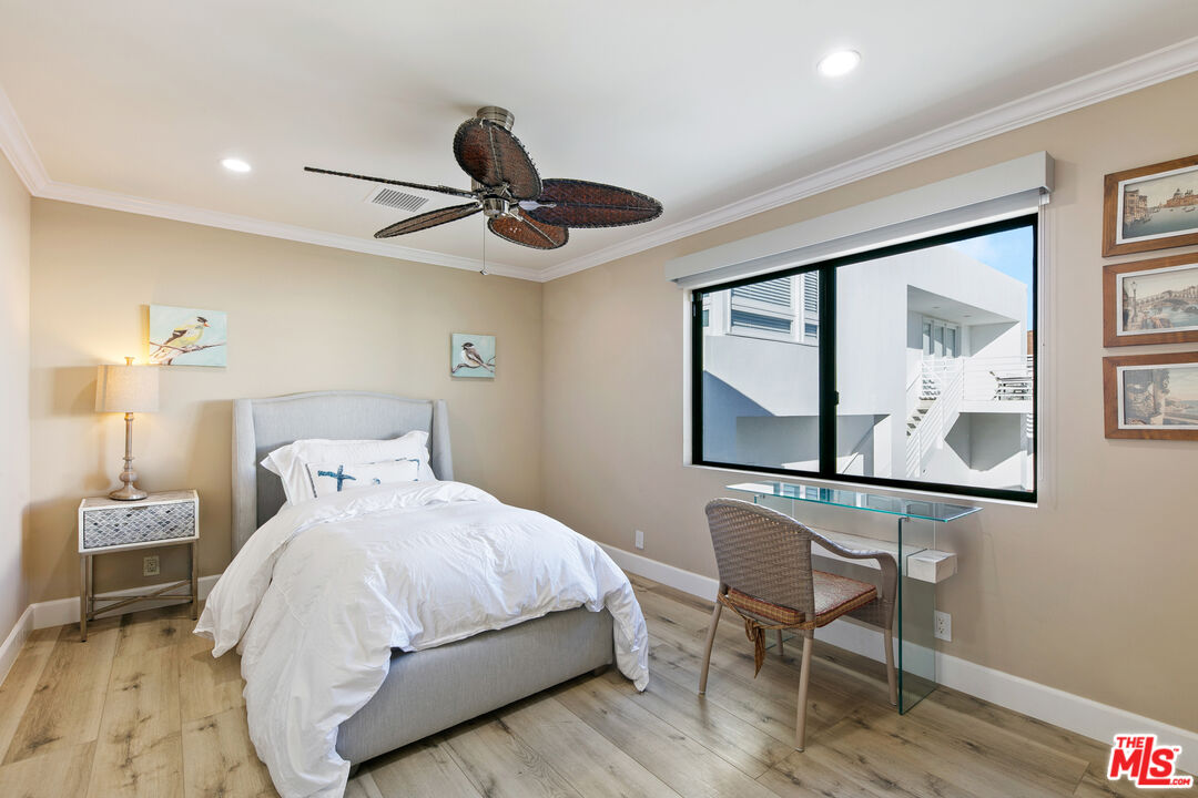 25216 Malibu Road Malibu, CA 90265 - Photo 16 of 21 a bedroom with a bed a desk and chair