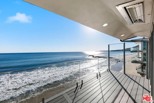 a view of a living room and a balcony