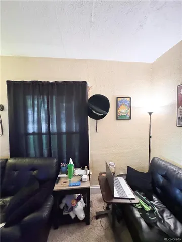 a living room with furniture and lamp