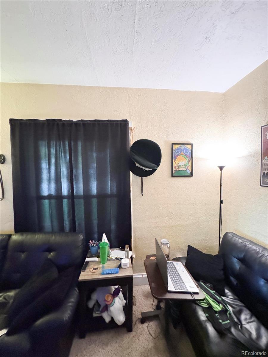 910 South Main Street Lamar, CO 81052 - Photo 11 of 18 a living room with furniture and lamp