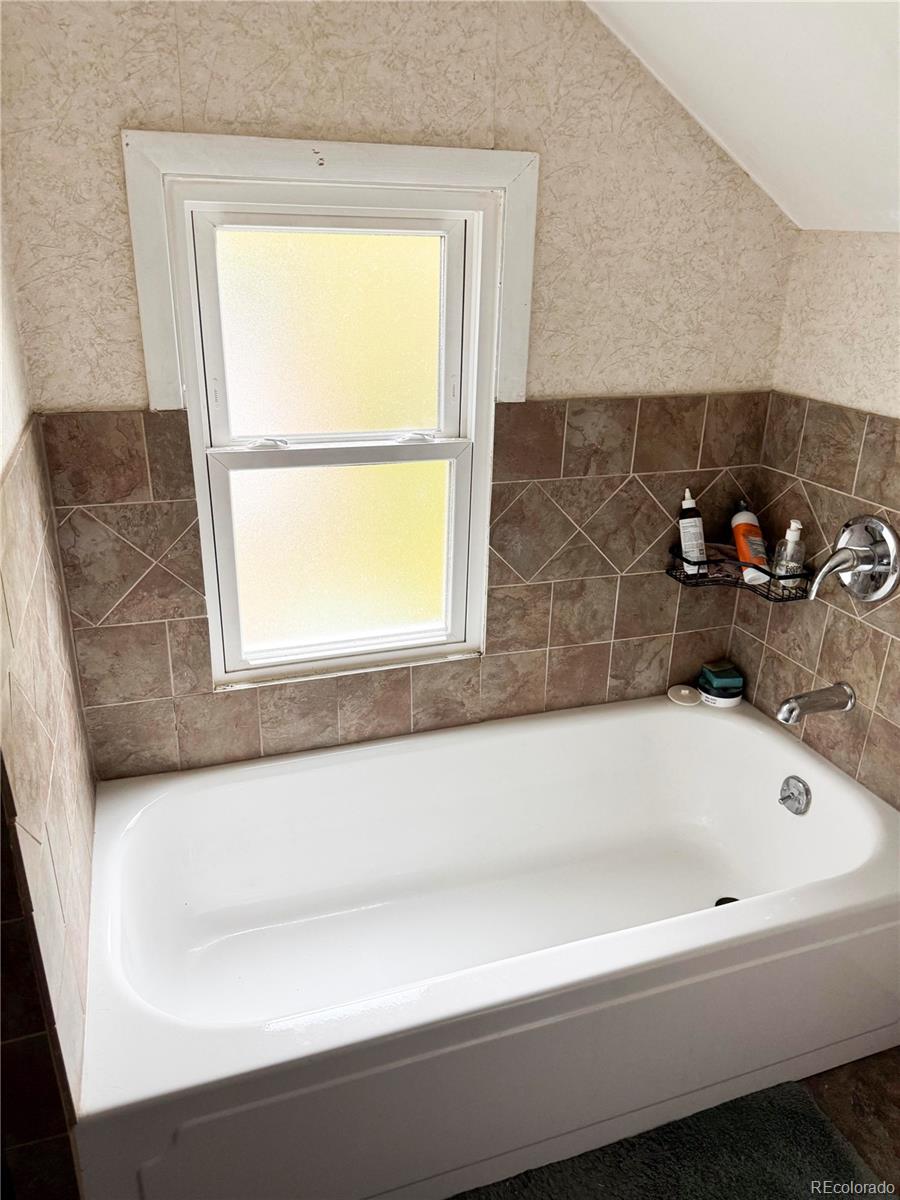 910 South Main Street Lamar, CO 81052 - Photo 14 of 18 a bathroom with a bathtub