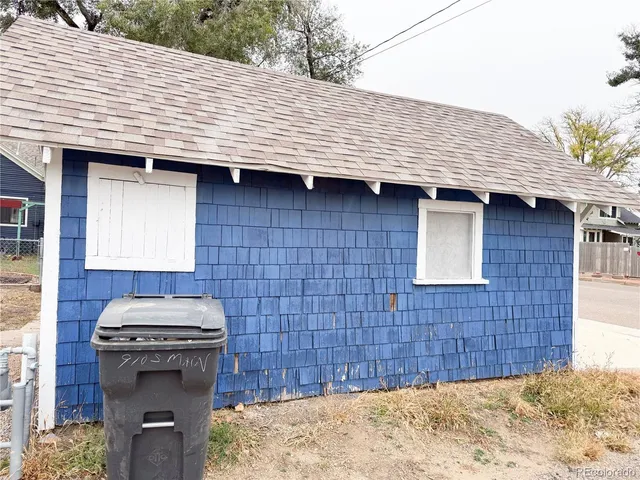 a view of a wooden house and a yard