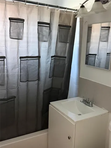 a bathroom with a sink and mirror