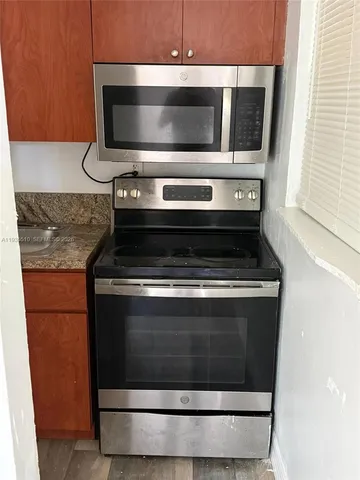 a stove top oven sitting inside of a kitchen