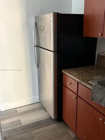 a white refrigerator freezer sitting in a kitchen
