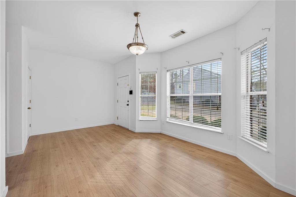 2527 Walden Lake Drive Decatur, GA 30035 - Photo 5 of 23 a view of an empty room with a window and wooden floor