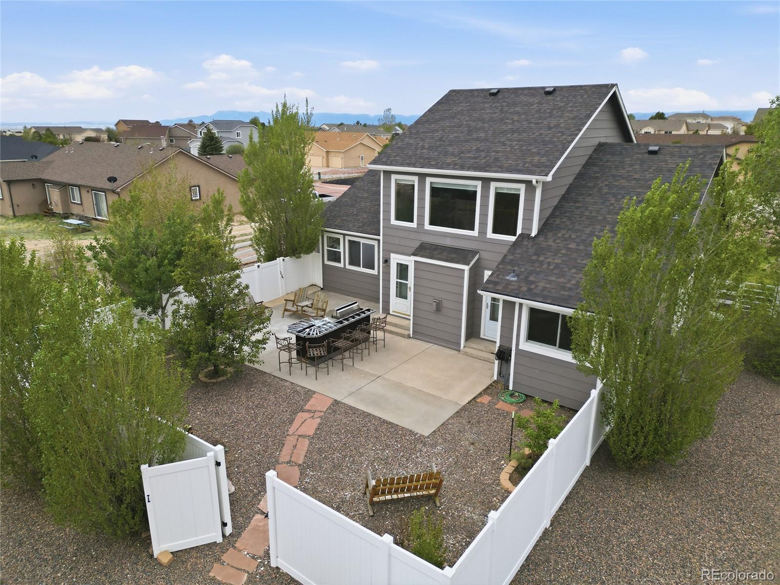 9288 Rockingham Drive Peyton, CO 80831 - Photo 38 of 49 an aerial view of a house with swimming pool and garden