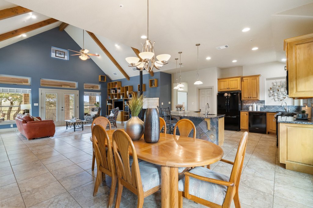 232 Crooked Oak Round Mountain, TX 78663 - Photo 11 of 40 Dining area with high vaulted ceiling, beam ceiling, a chandelier, recessed lighting, and a ceiling fan