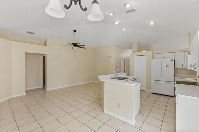 a kitchen with stainless steel appliances granite countertop a sink a stove a refrigerator and cabinets