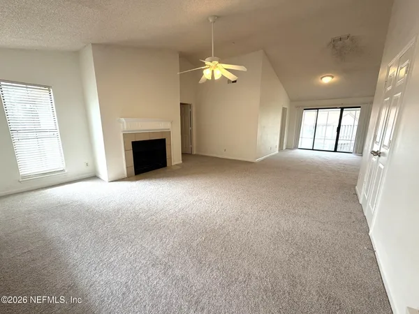 a view of empty room with a fireplace