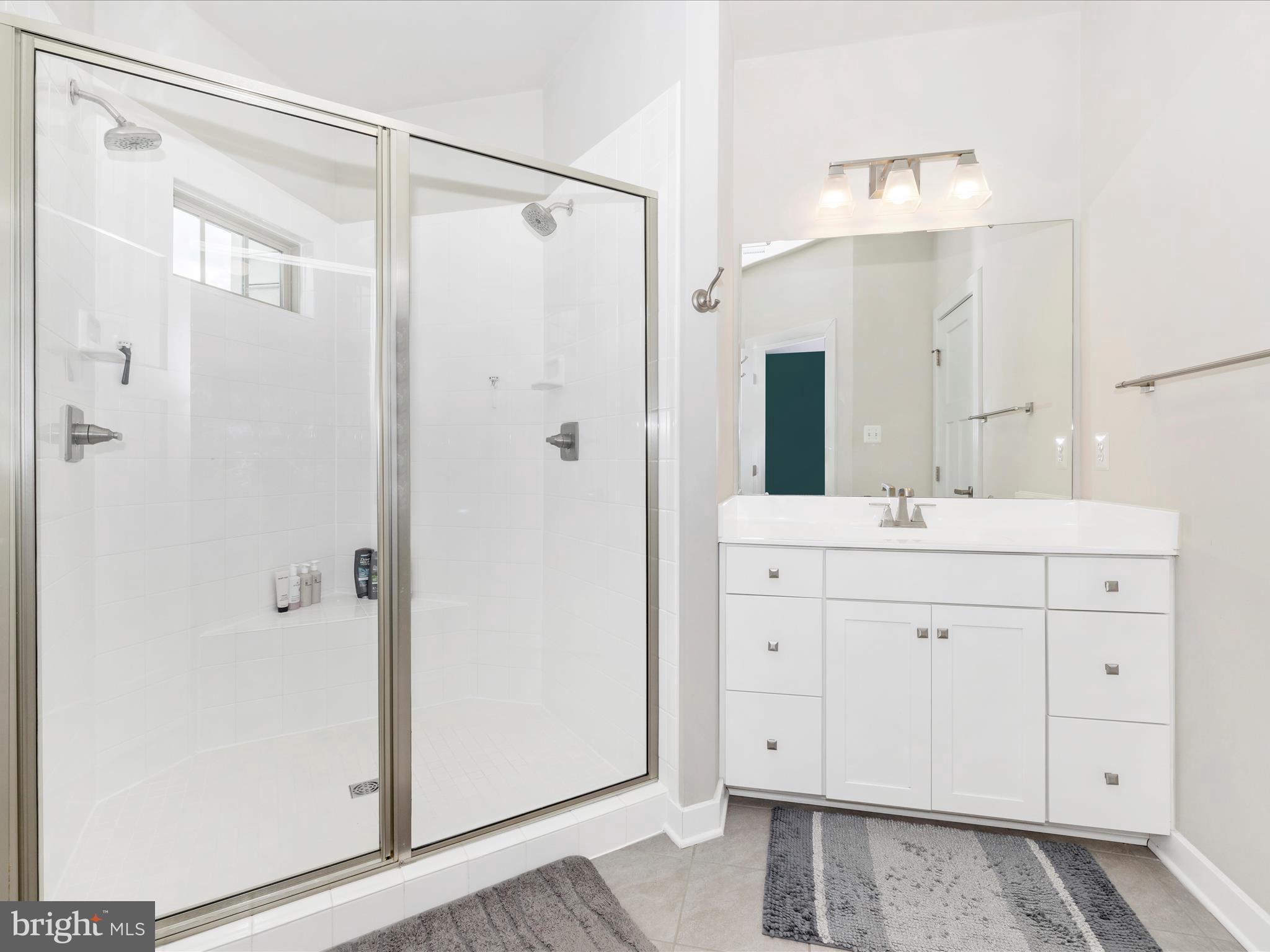 6020 Forum Square Frederick, MD 21703 - Photo 23 of 54 a bathroom with a double vanity sink mirror and shower