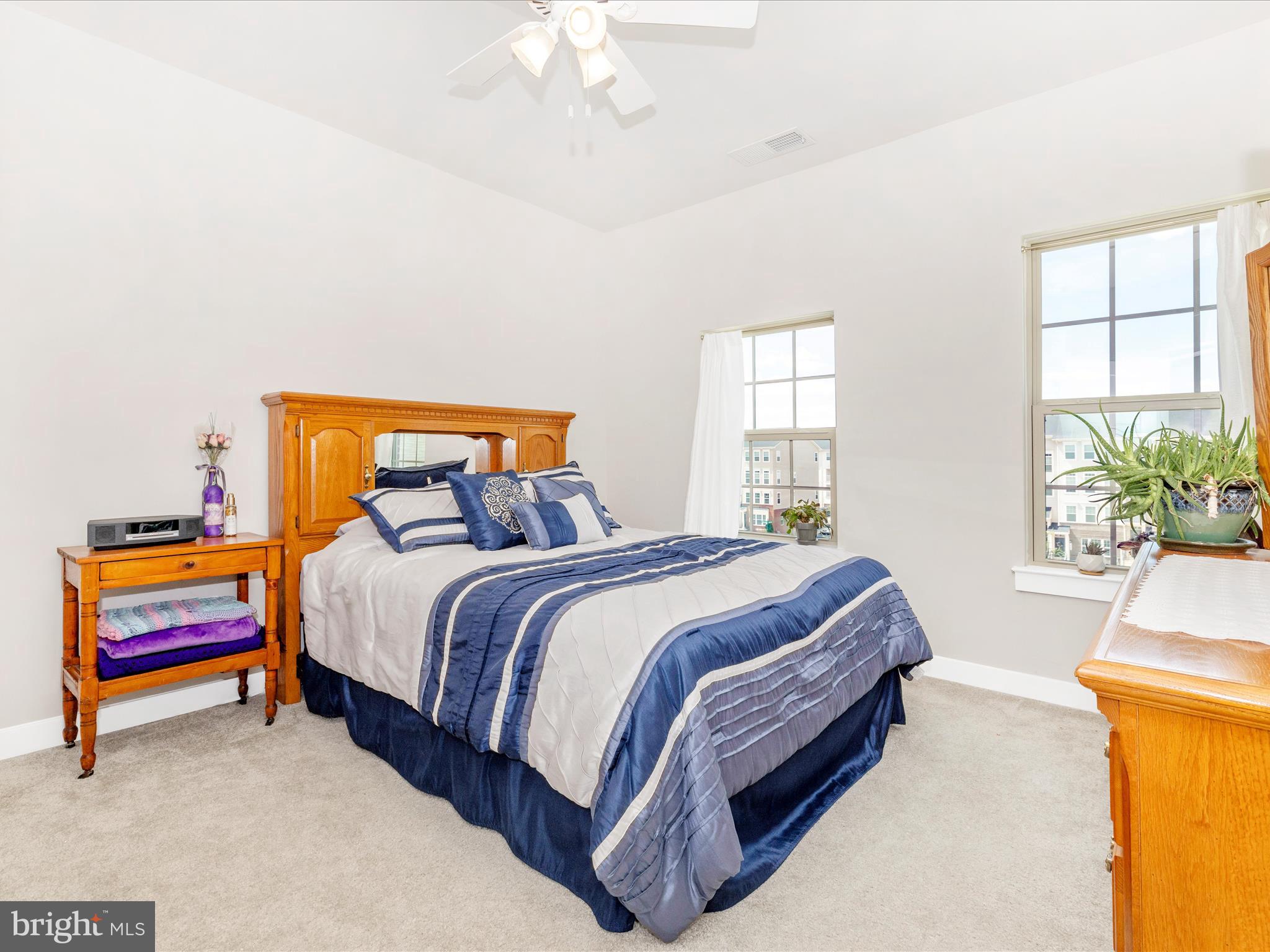 6020 Forum Square Frederick, MD 21703 - Photo 27 of 54 a bedroom with a bed and a painting on the wall